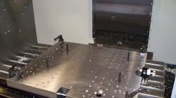 A precision-ground steel riser table features a matrix of tapped and jig bored holes. It is supported by a customized angle plate that also is precision ground. Using a combination of standard and modified clamping and location items, back-stopping and probe mounts are available for each component to be machined, so that rather than changing the table for each part the CNC operator can simply reposition the clamps to change the production run, in minutes.