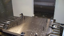 A precisionground steel riser table features a matrix of tapped and jig bored holes It is supported by a customized angle plate that also is precision ground Using a combination of standard and modified clamping and location items backstopping and probe mounts are available for each component to be machined so that rather than changing the table for each part the CNC operator can simply reposition the clamps to change the production run in minutes A precisionground steel riser table features a matrix of tapped and jig bored holes It is supported by a customized angle plate that also is precision ground Using a combination of standard and modified clamping and location items backstopping and probe mounts are available for each component to be machined so that rather than changing the table for each part the CNC operator can simply reposition the clamps to change the production run in minutes