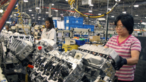 GM workers install lower head covers on Duramax diesel engines at the DMAX Ltd plant in Dayton Ohio