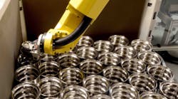 Once the finished bearing races have been automatically measured, the hard-turned components are engraved and then placed in shipping containers by the robot. Once the finished bearing races have been automatically measured, the hard-turned components are engraved and then placed in shipping containers by the robot.