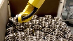 Once the finished bearing races have been automatically measured the hardturned components are engraved and then placed in shipping containers by the robot Once the finished bearing races have been automatically measured the hardturned components are engraved and then placed in shipping containers by the robot