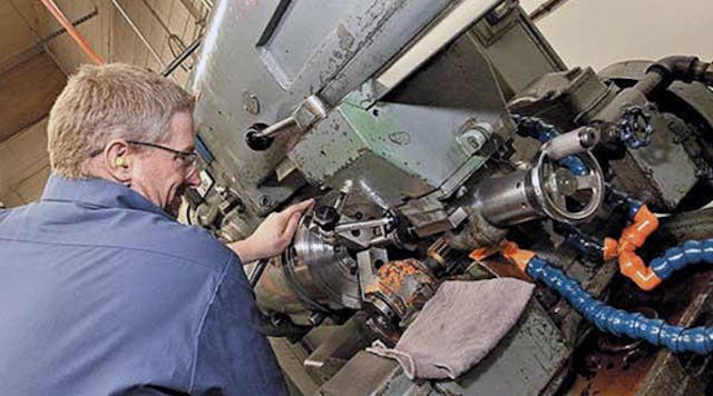 A machinist at another Boeing supplier sets a hob to cut splines in a torque tube for the Boeing 747-8.