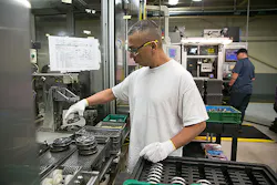 A GM employee assembles cam phasers at the General Motors Components Holdings LLC plant in Wyoming Mich