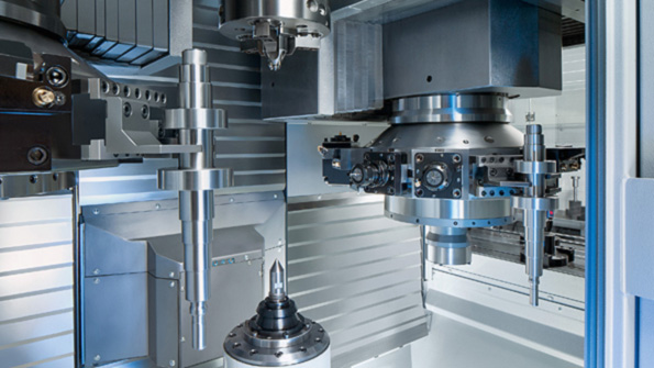 The machine is loaded and unloaded simultaneously with grippers located in the two turrets The workpieces are transported on conveyor belts located on the left and right of the machine