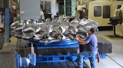 A hydropower “runner” in process at Canyon Hydro’s automated CNC facility in Sumas, Wash. — a shop that runs 24 hours/day, every day. Completing one runner is a five axis job that takes months, and produces one and a half ton of chips. The bulk of machining is handled with standard 2-inch indexable ball mills, but critical undercuts are completed with a modified standard Ingersoll button mill that makes chips on the way in and also on the way out. A hydropower “runner” in process at Canyon Hydro’s automated CNC facility in Sumas, Wash. — a shop that runs 24 hours/day, every day. Completing one runner is a five axis job that takes months, and produces one and a half ton of chips. The bulk of machining is handled with standard 2-inch indexable ball mills, but critical undercuts are completed with a modified standard Ingersoll button mill that makes chips on the way in and also on the way out.