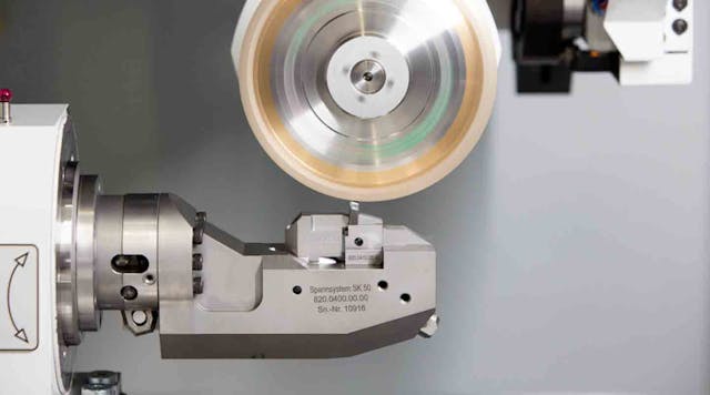 Machining a profile insert via the XING dressing technique on a HAAS Schleifmaschinen GmbH Multigrind CU grinding machine. The dresser wheel axis is not parallel to the grinding wheel axis, but rather at a 90&deg; angle, so the radius of the grinding wheel can be generated with the circumference of the dresser wheel, thus maintaining a consistent contact surface and pressure between dresser wheel and grinding wheel.
