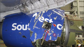 A view of the damaged left fan cowl of a Southwest Airlines 737 NG, as seen from the inboard side of the CFM56-7B engine, following the April 2018 in-flight engine failure.