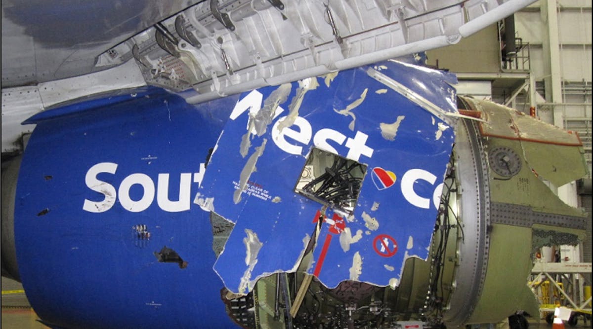 A view of the damaged left fan cowl of a Southwest Airlines 737 NG, as seen from the inboard side of the CFM56-7B engine, following the April 2018 in-flight engine failure.