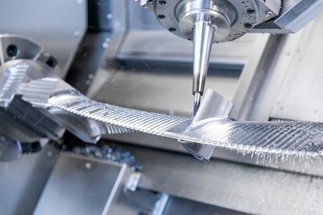 Five-axis machining is planned precisely to ensure smooth production of turbine blades.