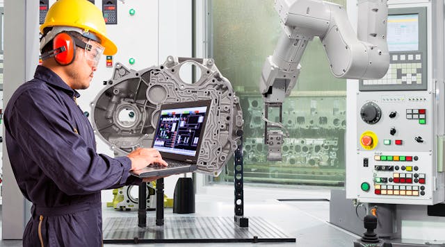 Engineer using laptop computer control automatic robotic hand with CNC machine in automotive industry, Smart factory concept.
