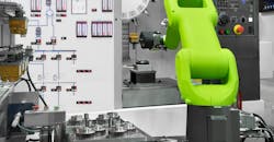 A robot tends to workpiece handling for a CNC machine, with finished automotive parts. A robot tends to workpiece handling for a CNC machine, with finished automotive parts.