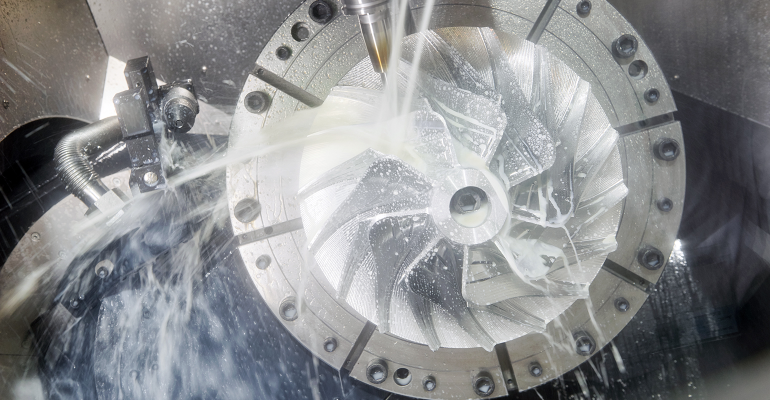 Vertical CNC milling machine in process.