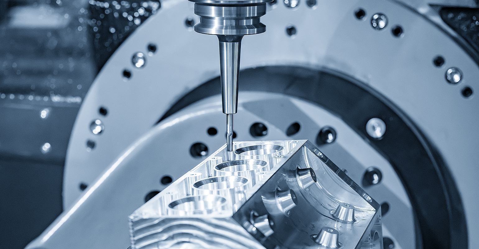5-axis CNC milling machine cutting an aluminum V8 engine block using solid ball endmill tool.