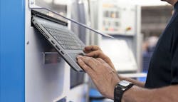 Programmer/machine tool operator at a control panel. Programmer/machine tool operator at a control panel.