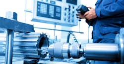 CNC machine and operator. CNC machine and operator.