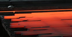 Hot steel long products on a walking cooling bed. Hot steel long products on a walking cooling bed.