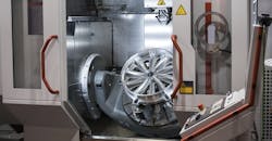 Machining an automotive wheel on a CNC five-axis machine.