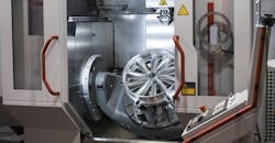 Machining an automotive wheel on a CNC five-axis machine. Machining an automotive wheel on a CNC five-axis machine.