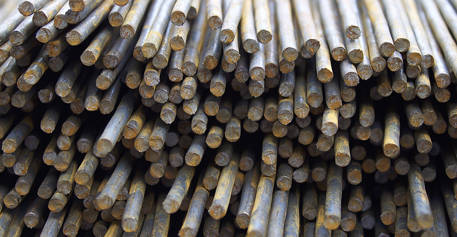 Steel reinforcing bars stored in a warehouse.