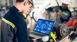 Factory worker working with adept robotic arm. Factory worker working with adept robotic arm.