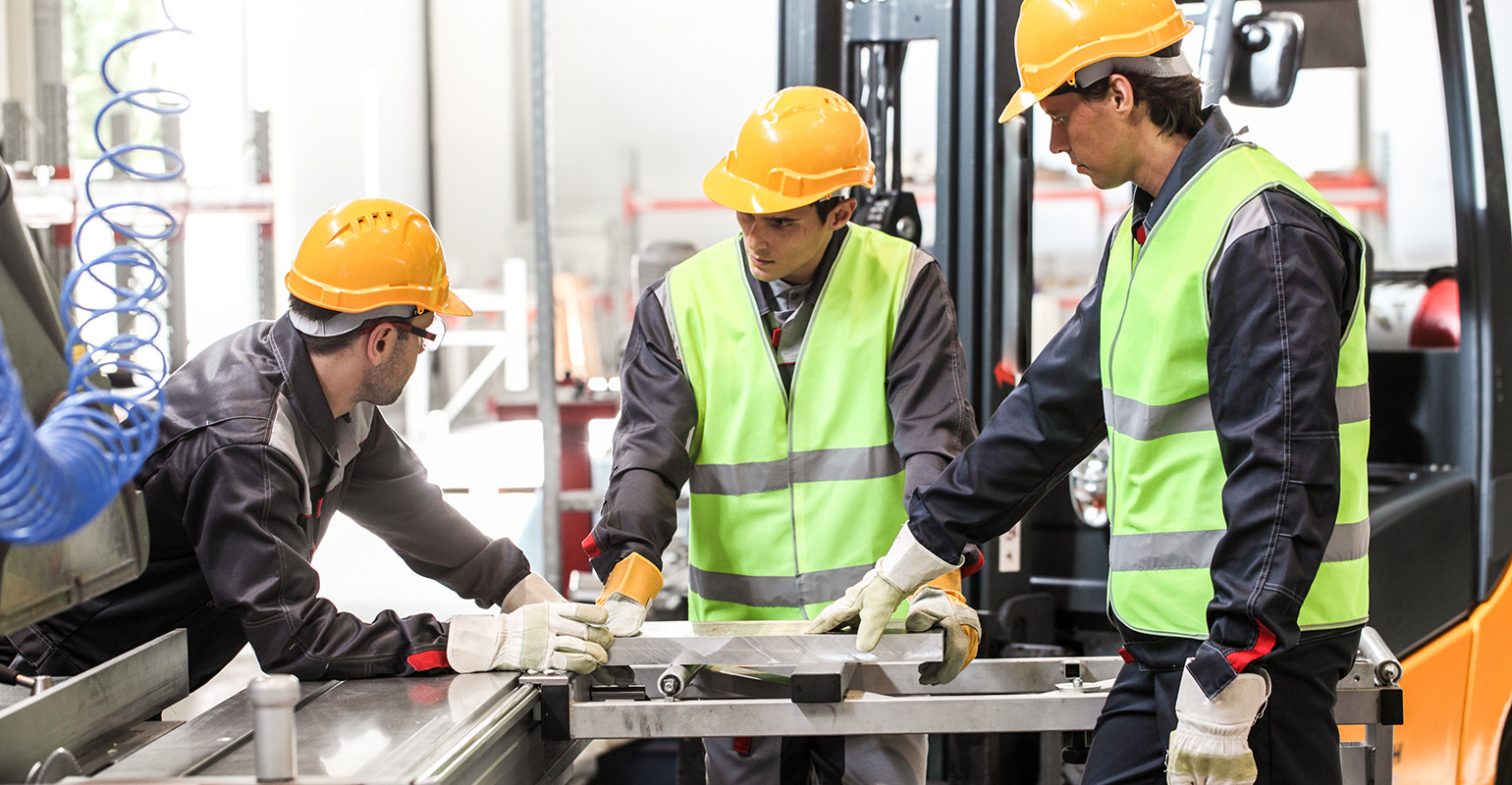 CNC machine shop workers in conversation.
