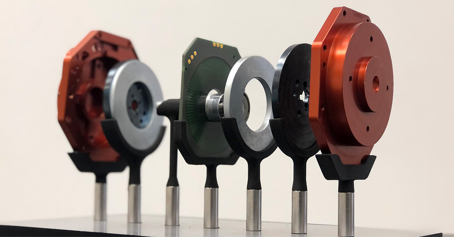 An exploded arrangement of an electric motor designed with ECM PCB Stator Technology, including the PrintStator CAD platform.