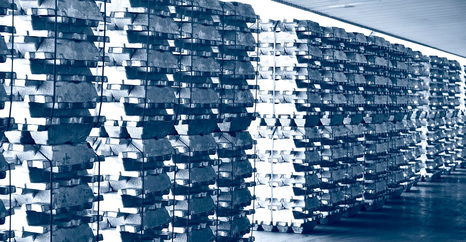 Aluminum ingots stacked in a warehouse.