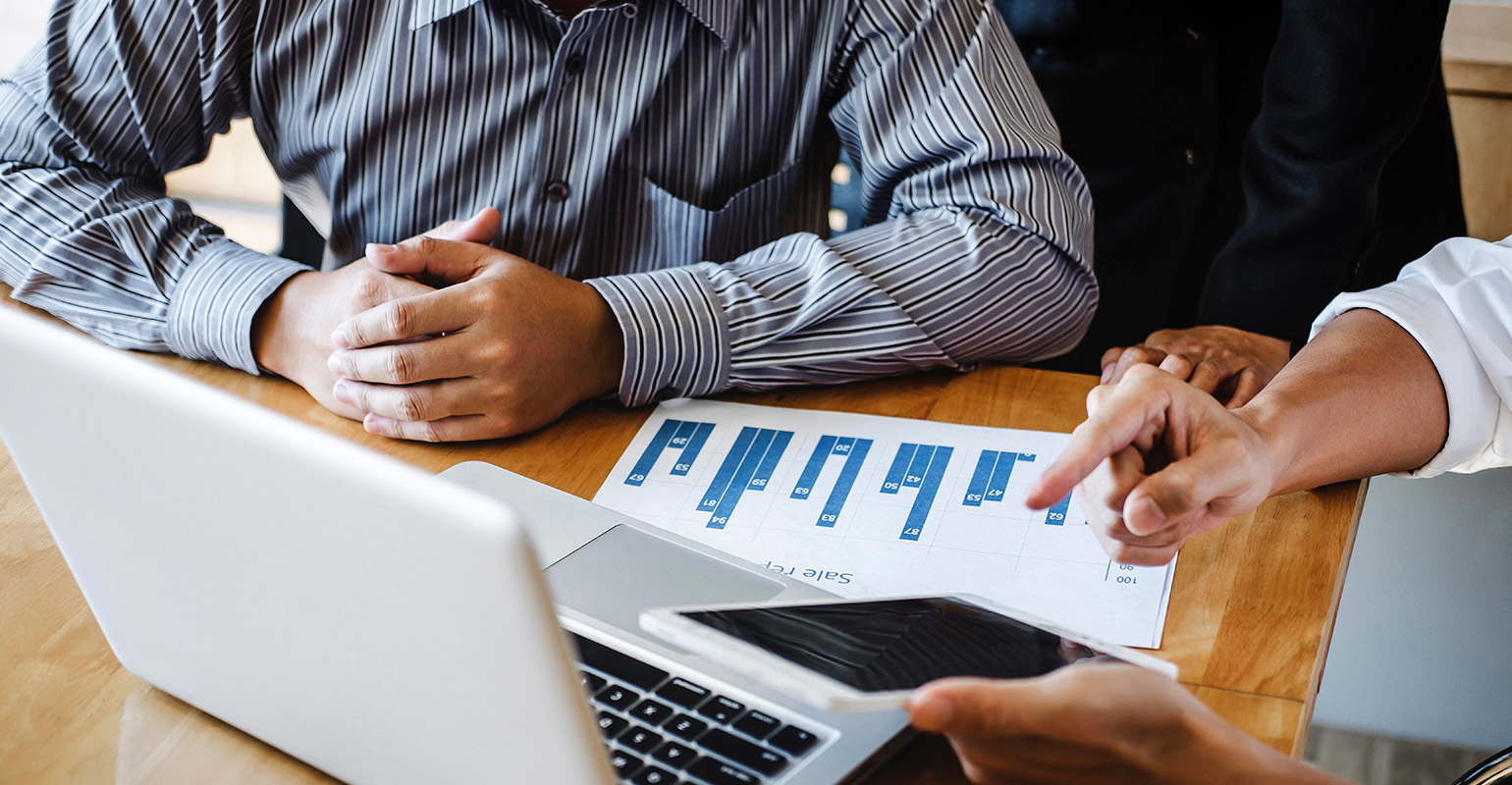 A business team evaluates project costs.