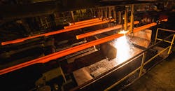 Continuous-cast steel billets at torch cutting.