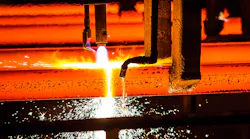 Oxy-torch cutting steel billets.