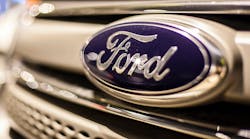 Ford blue oval logo on vehicle grille.