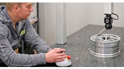 Ray Harris inspecting a scaled-down race car wheel for wind tunnel testing. Ray Harris inspecting a scaled-down race car wheel for wind tunnel testing.
