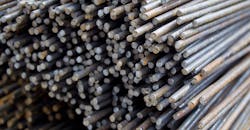 Stacked rebar, stored in a warehouse. Stacked rebar, stored in a warehouse.