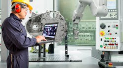 Smart factory concept: Engineer using laptop control with CNC machine in automotive industry. Smart factory concept: Engineer using laptop control with CNC machine in automotive industry.