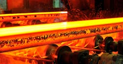 Hot steel slabs on continuous caster runout. Hot steel slabs on continuous caster runout.