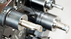 Cutting tools on an automated lathe. Cutting tools on an automated lathe.