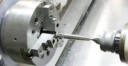 Operator machining mold-and-die part by CNC turning. Operator machining mold-and-die part by CNC turning.