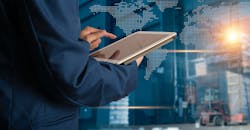 Executive using table to manage manufacturing logistics. Executive using table to manage manufacturing logistics.