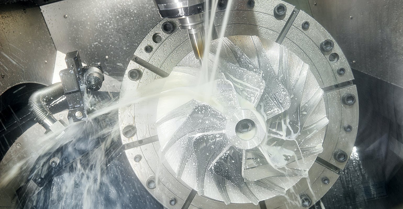 Vertical CNC machine cutting.