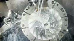 Vertical CNC machine cutting.