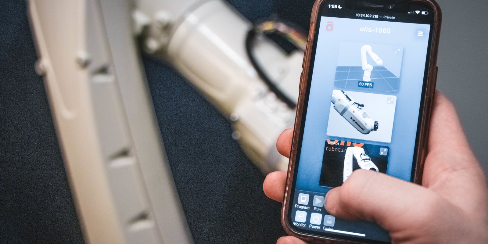 A technician accesses a Kawasaki robotic arm using Olis' remote-control application.