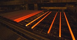 Hot steel billets cooling on a runout table. Hot steel billets cooling on a runout table.