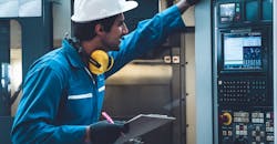Worker engaged with CNC machine in a smart manufacturing shop. Worker engaged with CNC machine in a smart manufacturing shop.