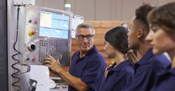 Training CNC machine shop workers. Training CNC machine shop workers.