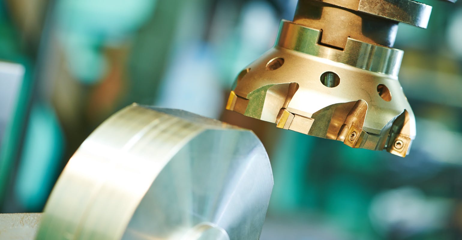 Close-up of machining by milling cutter with hard metal carbide insert.