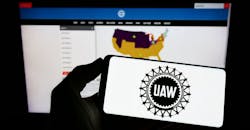 Smart phone showing United Auto Workers union logo. Smart phone showing United Auto Workers union logo.