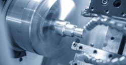 A CNC lathe machine cutting the thread at the metal parts. A CNC lathe machine cutting the thread at the metal parts.