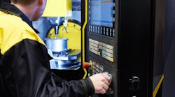 A CNC machine operator. A CNC machine operator.