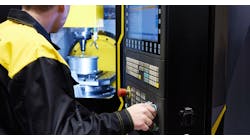 A CNC machine operator. A CNC machine operator.