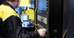 A CNC machine operator. A CNC machine operator.